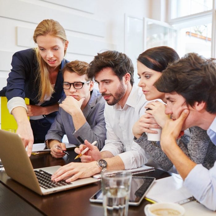 How to motivate a team to achieve results. IT Team working on laptop.